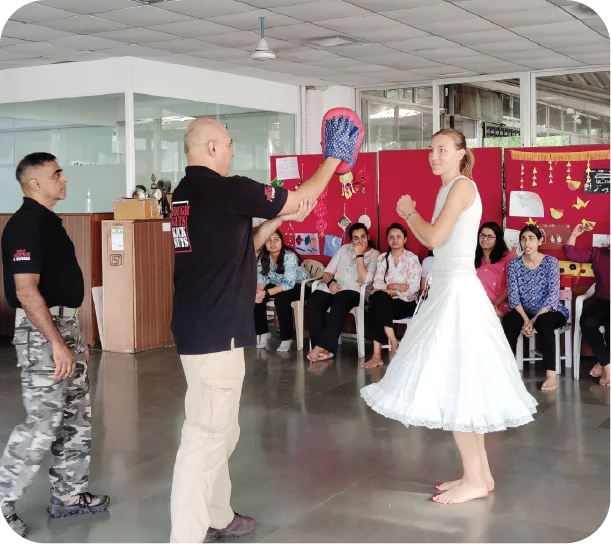 Trainer demonstrating situational response techniques in indoor training setup